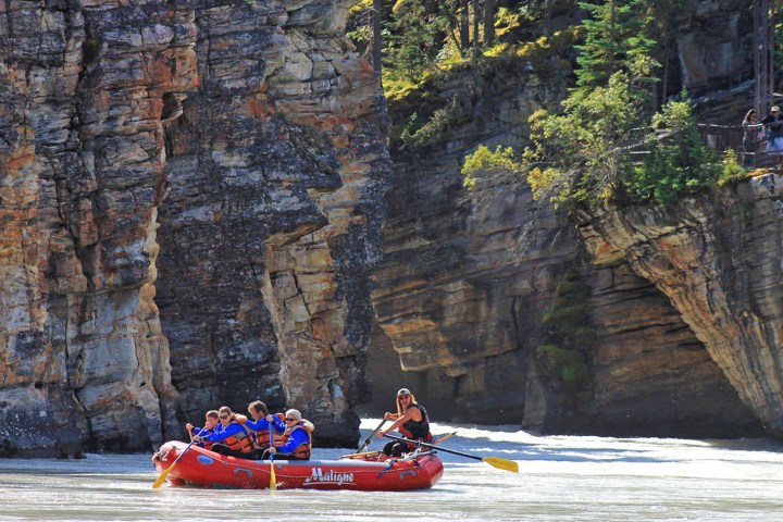 a person in a raft on a rock