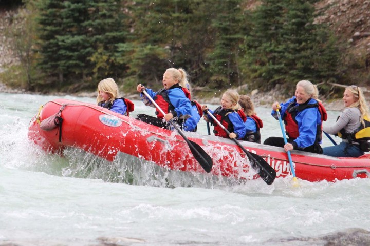 a group of people riding on the back of a boat