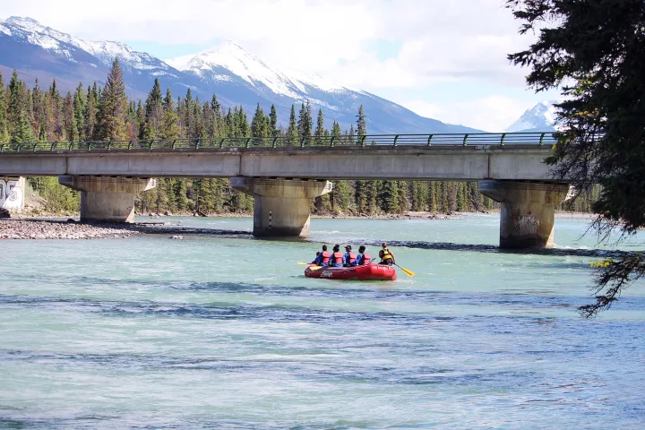 a train crossing a bridge over a body of water