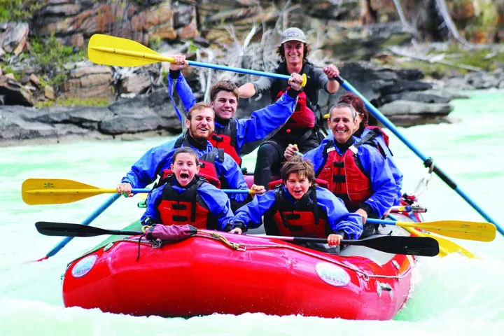a group of people on a raft in a body of water