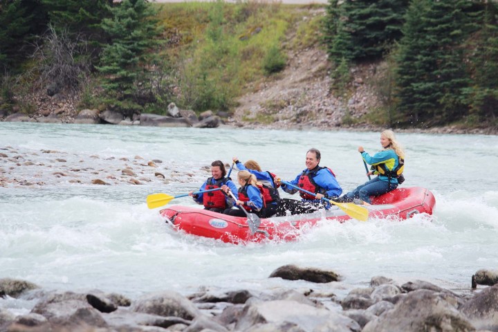 a group of people on a raft in a body of water